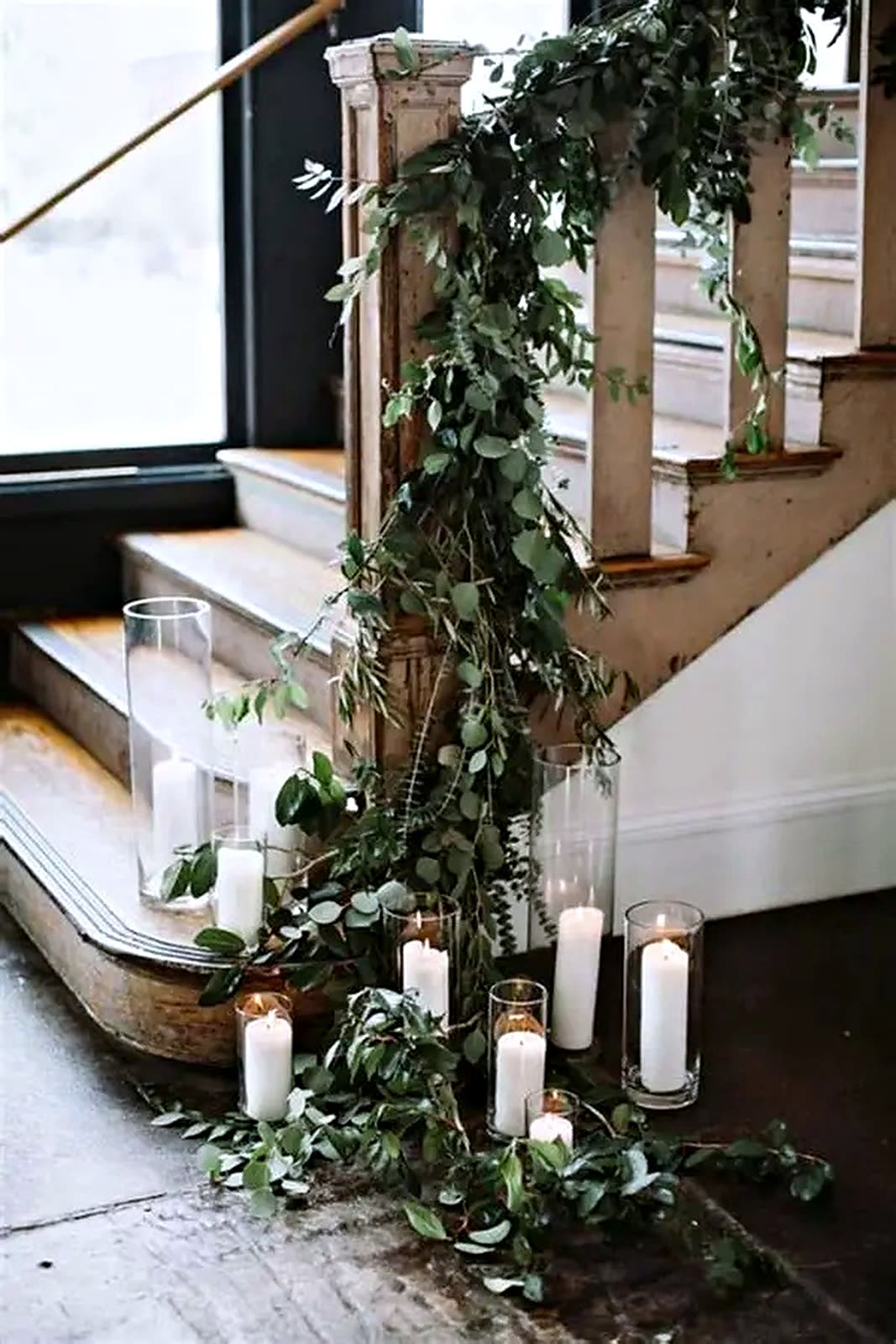 Candlelit staircase garland with lush greenery
